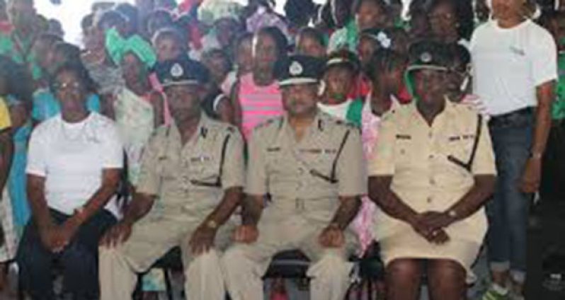 Top brass of the GPF pose with children of one of the annual youth camps