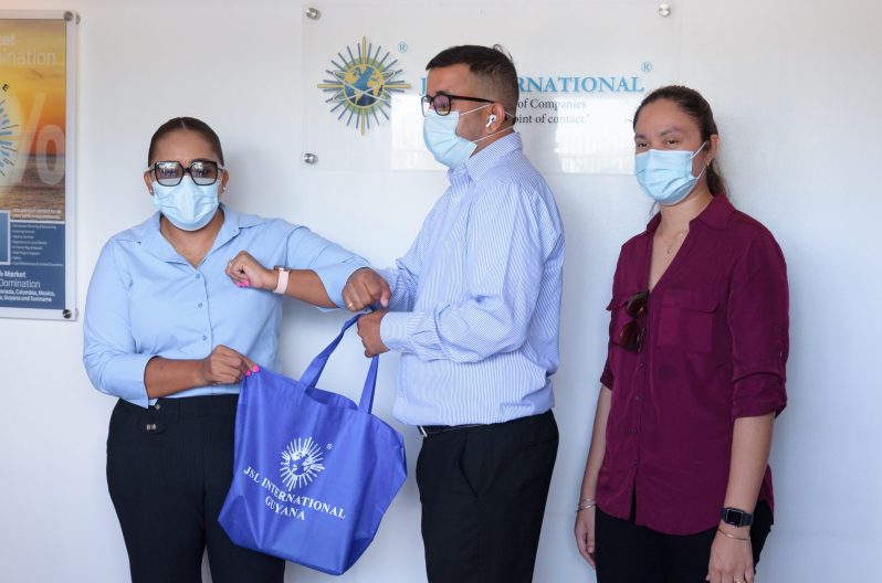 JSL international representative, Renatta Bovell, handing over some of the donated items to Ganesh Singh and Annie Singh (Delano Williams photo)