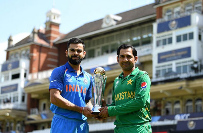 The captains Virat Kohli (India) and Sarfraz Ahmed  (Pakistan) pose with the Champions Trophy in front of the famed pavillion at The Oval, London, Saturday.