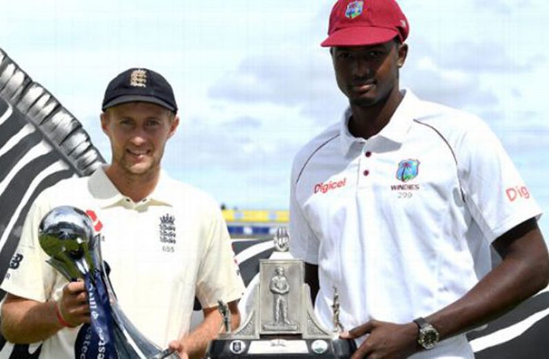 Captains Joe Root and Jason Holder pose with the Investec series trophy and the Wisden Trophy (Getty Images)