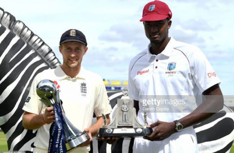 England captain Joe Root and West Indies captain Jason Holder pose with the series trophies at Kensington Oval. (Getty Images)