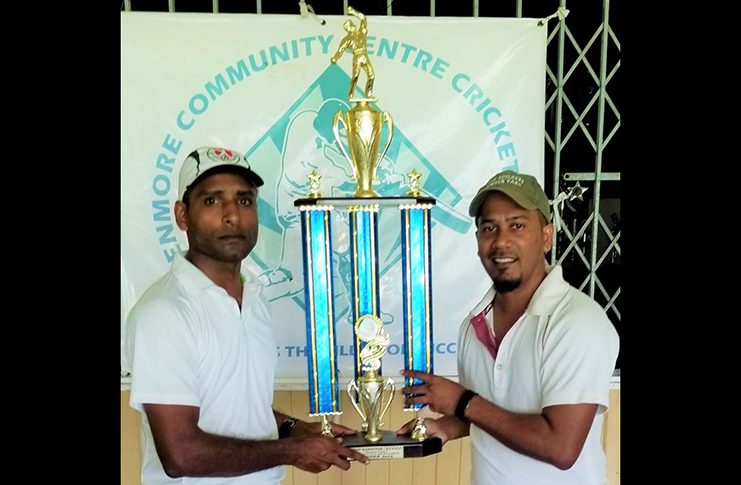 Enmore CCCC skipper Bheemraj Ramkelawan (left) and Ogle CC Blasters captain Davindra Ramtahal with the championship trophy.
