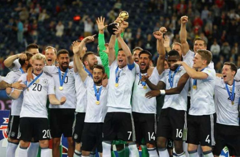 Germany’s Julian Draxler celebrates with the trophy and teammates after winning the FIFA Confederations Cup REUTERS/Kai Pfaffenbach