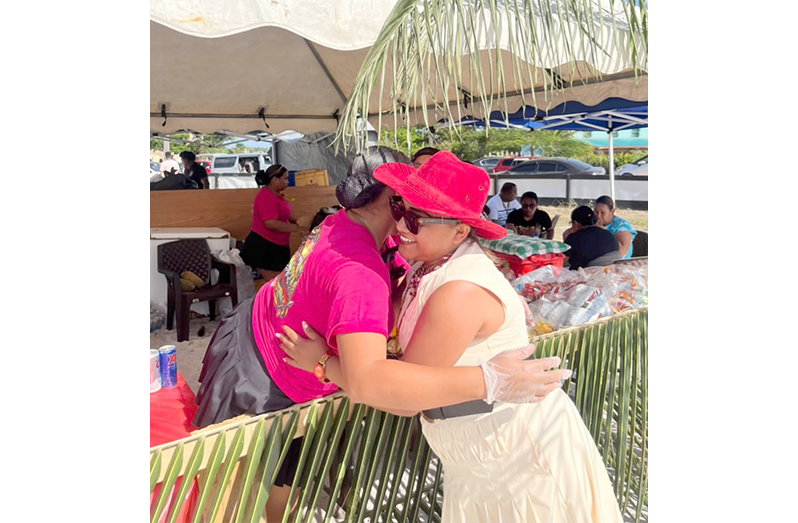 Director-General Ministry of Amerindian Affairs Sonia Latchman warmly embraces a resident during the Heritage Day celebration