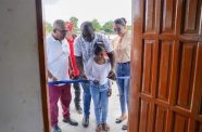 Minister within the Office of the Prime Minister with responsibility for Public Affairs, Kwame McCoy, cuts the ribbon to commission the centre