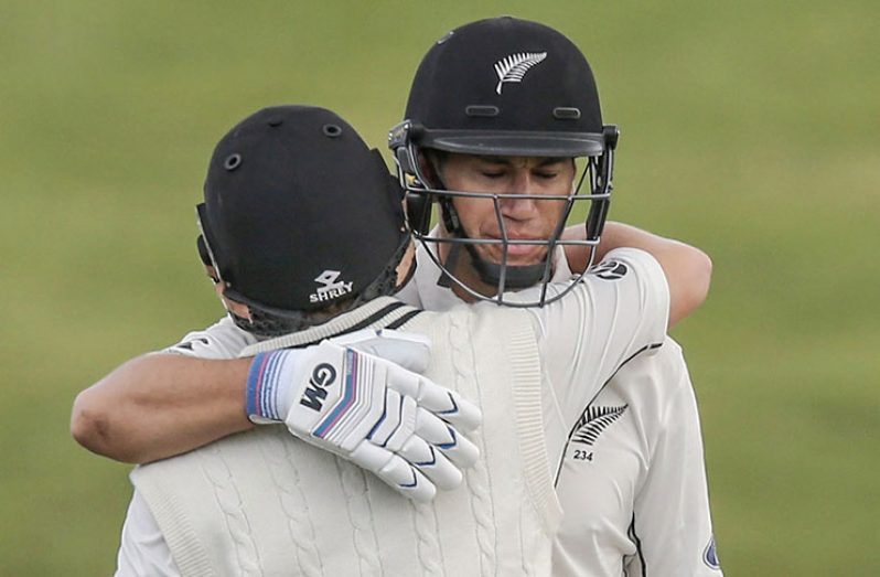 Ross Taylor hugs BJ Watling after bringing up his century on the 4th day in Hamilton.