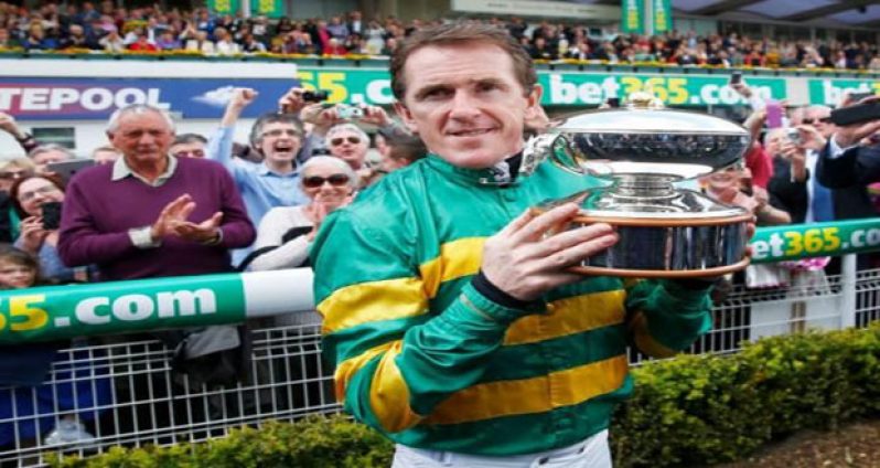 A.P McCoy celebrates with the Champions Jockey Trophy (Reuters / Eddie KeoghLivepic)