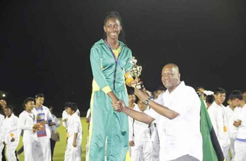 Beyonce Ross as she receives her prize from Minister of State, Joseph Harmon, at the National Schools Championship in November 2017.
