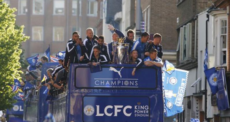 Leicester City manager Claudio Ranieri, Danny Simpson, Kasper Schmeichel, Riyad Mahrez, Andy King, Christian Fuchs, Danny Drinkwater, Leonardo Ulloa, Robert Huth and Jamie Vardy with the trophy on the bus during the parade (Reuters/Phil Noble)