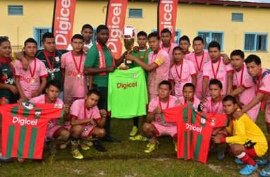 Region 7 winners, DC Caesar Fox Secondary School, pose with their spoils after beating Three Miles Secondary 5-0 in Bartica. At centre, the captain collects his trophy from Digicel representative Mario Grimshaw. (Adrian Narine photos)