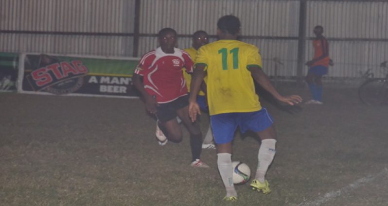 Pele’s Gregory Richardson (11) takes on a Buxton United defender in their round three Stag Elite League match last night at the Tucville Ground. (Delano Williams Photo)