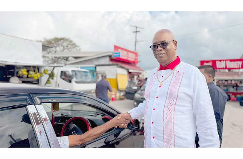 Public Works Minister Juan Edghill greets residents during his visit to Charity on Friday