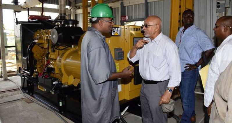 President Donald Ramotar chatting with a GPL worker at the Leguan Power Station, yesterday (Sandra Prince photo)