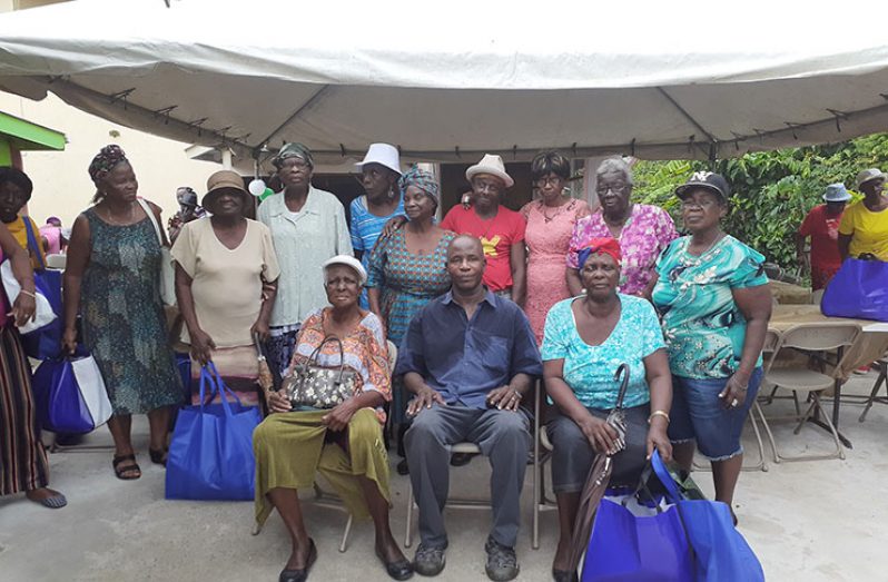 Pastor Terry Thomas along with several elderly persons who attended the annual Christmas party.