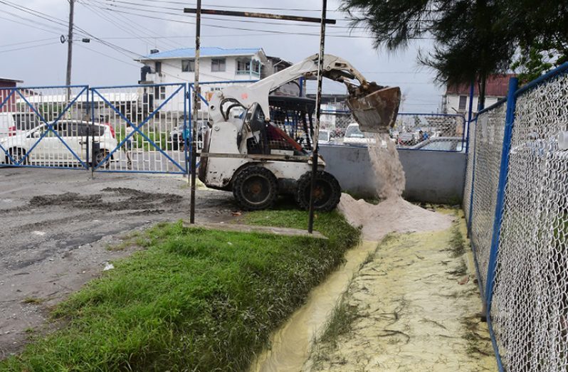 A clean-up exercise underway at the area on Lombard Street.(Adrian Narine photo)