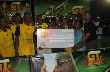 Champions Winners Connection receive their $1M cheque from Ms Shondel Easton. Banks DIH Linden Branch Manager, and Errol Nelson, Banks DIH Aqua Mist Manager, after copping the championships for the second straight year.