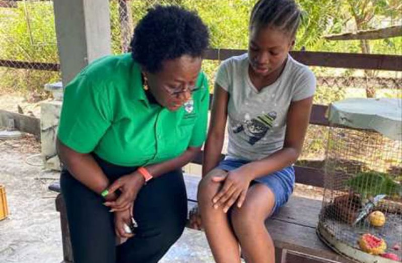 Orissa Noble shows Minister Broomes a minor injury she suffered