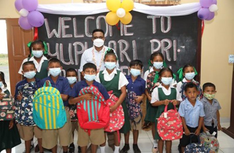 Local Government and Regional Development Minister, Nigel Dharamlall, with the pupils of Fly Hill