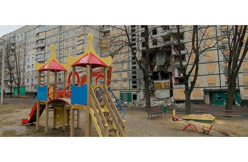 A children’s playground in front of a heavily damaged residential building in Kharkiv (UNICEF/Stas Bilyk)