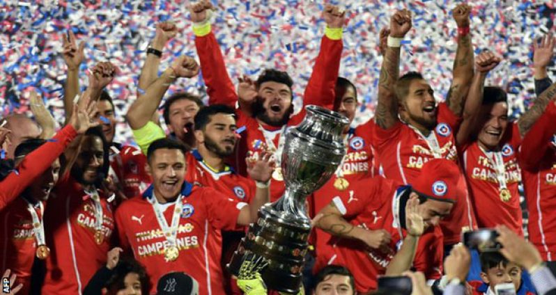 Chile footballers celebrate with the Copa trophy. It was their first Copa America win after 173 games played in this competition, dating back to the first tournament in 1916.