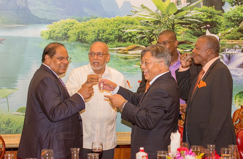 Prime Minister Moses Nagamootoo shares a toast with Former President, Donald Ramotar, China's Ambassador, Cui Jianchun; Speaker of the National Assembly, Dr Barton Scotland and Minister of Public Infrastructure, David Patterson (Samuel Maughn photo)