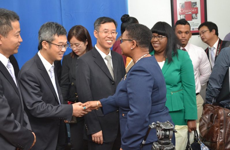 Guyana’s Health Ministers Volda Lawrence (in blue) and Dr. Karen Cummings (in green) greeting the members of the delegation