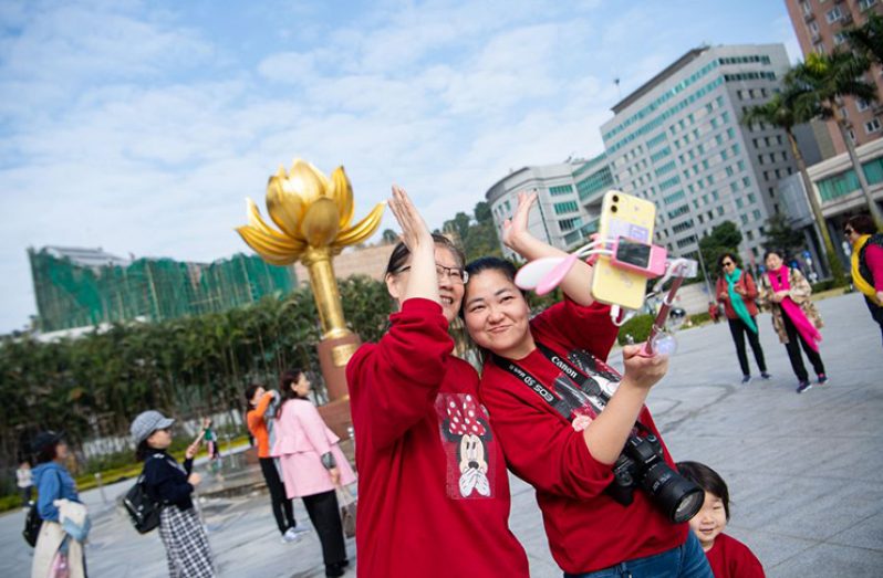 People visit the Golden Lotus Square in Macao, south China, Dec. 13, 2019. (Xinhua/Cheong Kam Ka)