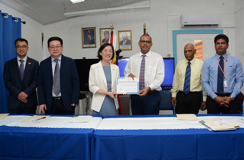 Minister of Health Dr Frank Anthony (third from right) and Chinese Ambassador to Guyana, Guo Haiyan (third from left), during the signing ceremony on Friday