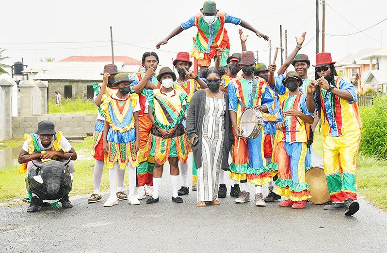 A quick snap with the Victoria Renegades Masquerade Band before they head out to the main road to perform (Samuel Maughn photo)