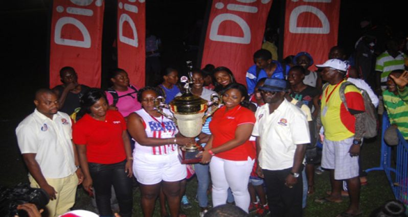 A representative from the Police Progressive Youth Club receives the winning trophy for the Boyce and Jefford Track and Field Classic VI.