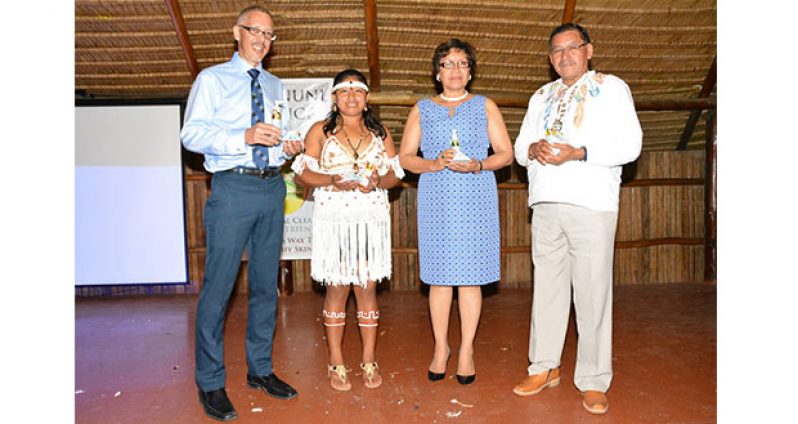 Minister of Business, Mr. Dominic Gaskin, a young woman, who is featured in the advertising campaign of the Luxury Facial Cleanser, Minister within the Ministry of Indigenous People’s Affairs, Ms. Valerie Garrido-Lowe and Vice President and Minister of Indigenous People’s Affairs, Mr. Sydney Allicock display the a few bottles of the cleaner and the soap.