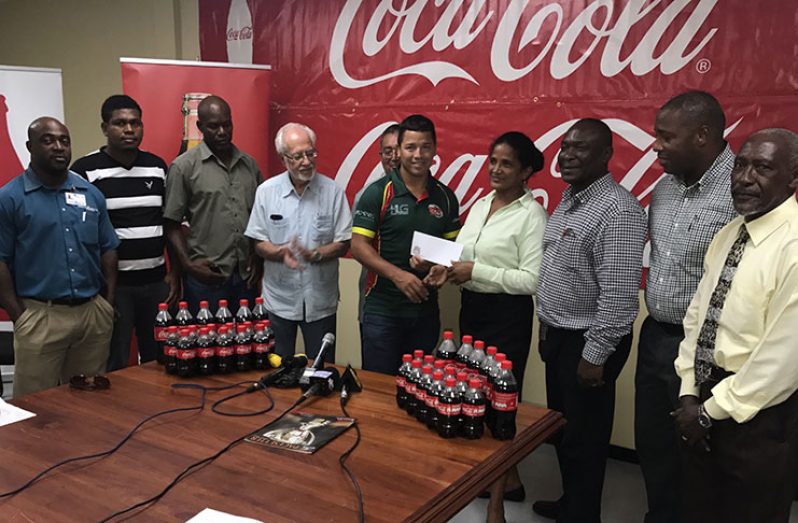 Coca Cola Brand Manager Jenifer Khan makes a presentation to Green Machine Caprain Ryan Gonsalves, while other officials of the GRFU and Banks DIH look on)