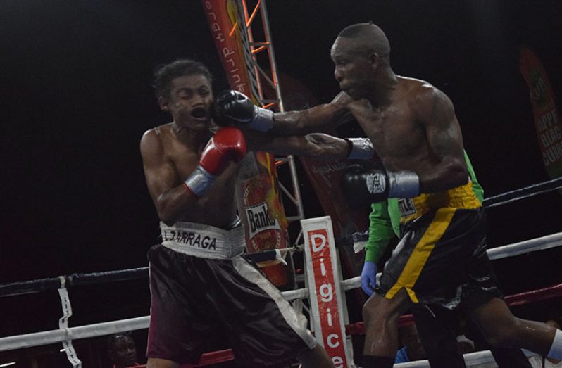 Dexter Marques (right) connects with a straight right to the jaw of Zarraga during their 10-round lightweight contest at the Giftland Mall on Sunday night. (Photo by Culloen Bess-Nelson)
