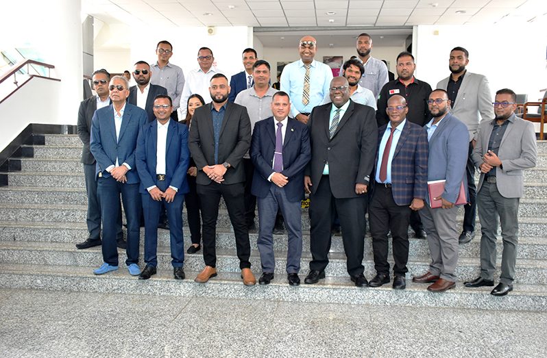 Housing and Water Minister, Collin Croal (front row, third from left); Chief Executive Officer of the Central Housing and Planning Authority (CH&PA), Sherwyn Greaves (front row, fourth from left) and CH&PA Chairman of the Board of Directors, Emanuel Cummings (front row, fifth from left) with the contractors and other officials
