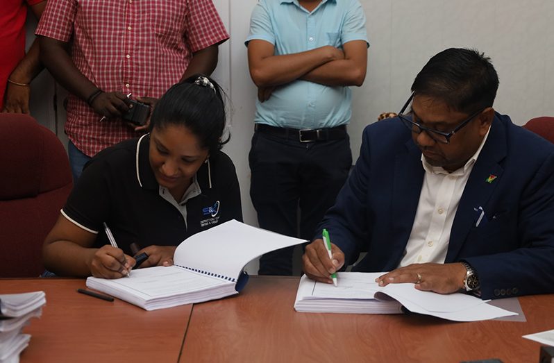 Among the 24 contracts signed on Wednesday, several contracts totalling in excess of $535.4 million were awarded to the Guyana Sugar Corporation (GuySuCo). In photo, the company’s CEO, Sasenarine Singh, signs one of the contracts (Ministry of Agriculture photo)