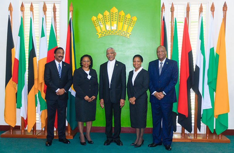 Puisne Judge Fidela Corbin-Lincoln (second right) stands with President David Granger (centre); Minister of State, Joseph Harmon (right); Chancellor of the Judiciary, Justice Yonette Cummings-Edwards (second left); and Attorney General and Minister of Legal Affairs, Basil Williams on Wednesday after taking the oath of office (Delano Williams photos)