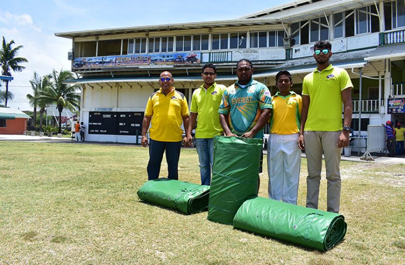 Saheed Mohamed (centre)  and Anthony Khan (2nd from right) receive the covers from staff of Regal Stationery and Computer Centre and Regal Sport. From left: Mario Allicock, Russel Jagbeer and Romesh Boodhoo (Freelancer photo)