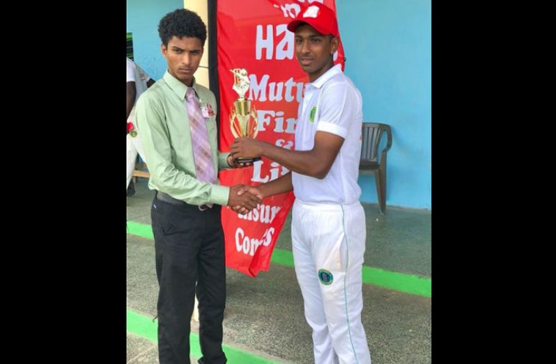 Hand-in-Hand Insurance Company representative Jesse Rahamatullah (left) presents the man-of-the-match prize to the Berbice destroyer Kelvin Umroa for his seven wickets for 16 runs.