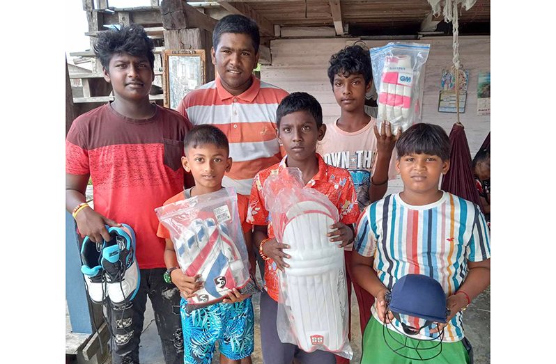 The young cricketers proudly display their gear.