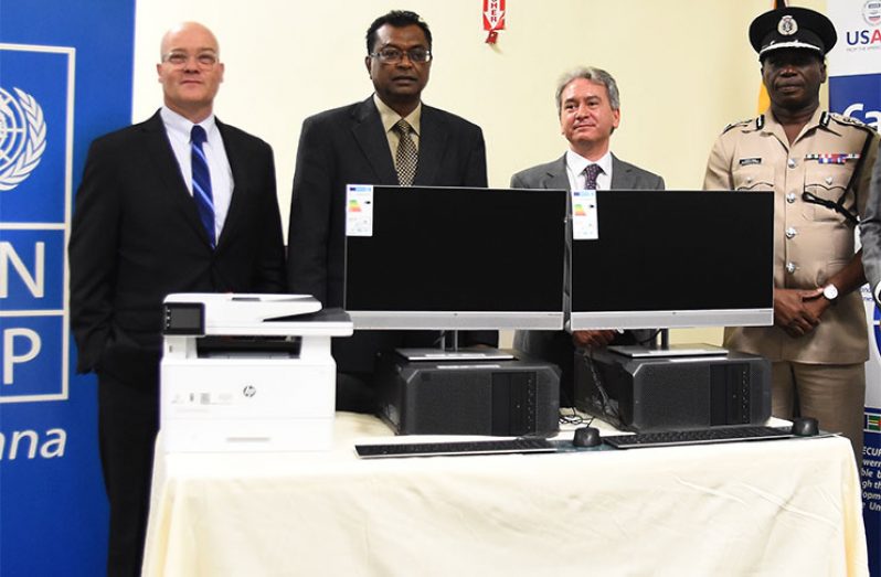 From left: US Deputy Chief of Mission, Mark Cullinane; Public Security Minister, Khemraj Ramjattan; UNDP Resident Representative, Luca Renda; and Commissioner of Police, Leslie James at the official handing-over of the two computer systems that will be assigned to the two police stations (Samuel Maughn photo)