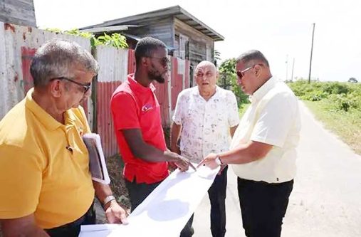 Minister of Housing and Water Collin Croal and a technical team from the ministry inspect the informal settlement at the Vergenoegen Sea Dam