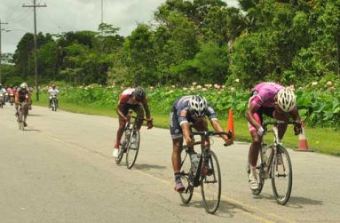 Newly crowned champion Geron Williams gets out of his saddle to make the final push for the line ahead of Marlon 'Fishy' Williams, while the dethroned Raynauth Jeffrey (background) finishes third.