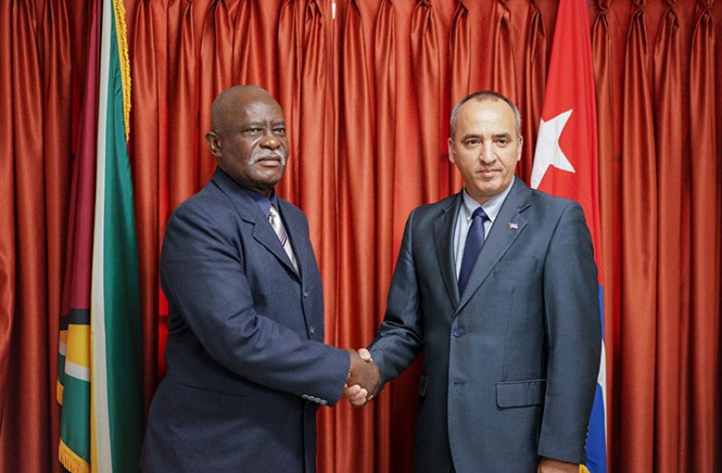 Minister of Citizenship Mr. Winston Felix (left) and Director of the Division of Consular Affairs and Cuban Residents Abroad, Mr. Ernesto Soberon Guzman (right), shake hands after a successful meeting