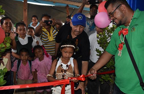 Vice President and Minister of Indigenous Peoples’ Affairs Sydney Allicock assisting in the cutting of the ribbon to signal the opening of the new shop