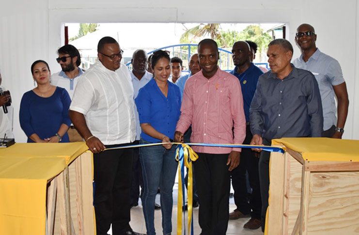 Mayor Gifford Marshall cuts the ribbon to the new ANSA McAL location, while Regional Chairman, Gordon Bradford (right) and ANSA McAL Marketing Director, Troy Cadogan looks on (Ministry of the Presidency photo)   The new Ansa McAl branch in Bartica, Region seven