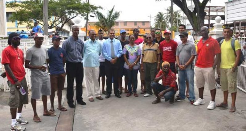 Sport Minister Dr Franck Anthony, Director of Sport Neil Kumar and Permanent Secretary Alfred King pose with the cyclists before they left the Ministry’s compound for Berbice, yesterday.
