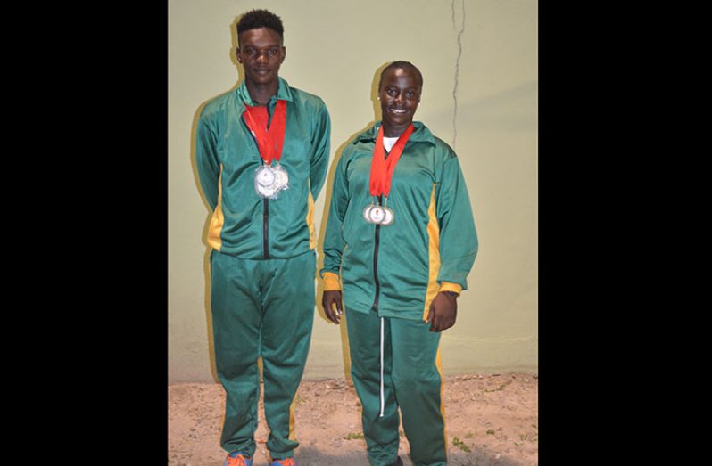 Boys 40km winner, Andrew Hicks and Girls’ 25km winner Shenika Teixeira display their medals at the presentation ceremony last night at the Providence Stadium.