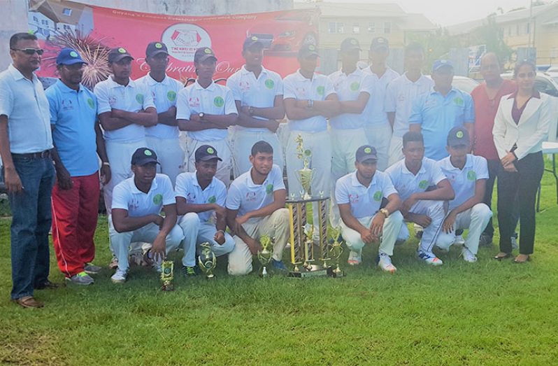The Demerara U-19 team pose with their trophy in the presence of GCB and Hand-in Hand officials.