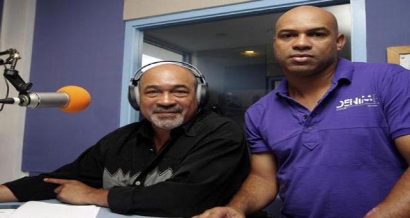 Former Surinamese dictator Desi Bouterse (L), head of the country's opposition National Democratic Party (NDP), poses with his son Dino at Radio 10 in Paramaribo, May 22, 2010.
