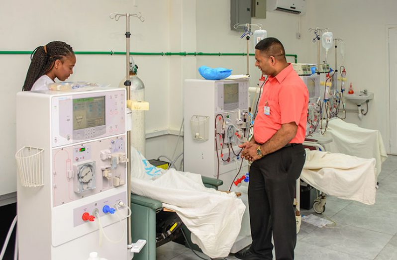 Head of the Nephrology Department, Dr. Kishore Persaud and a nurse attending to a patient receiving Haemodialysis